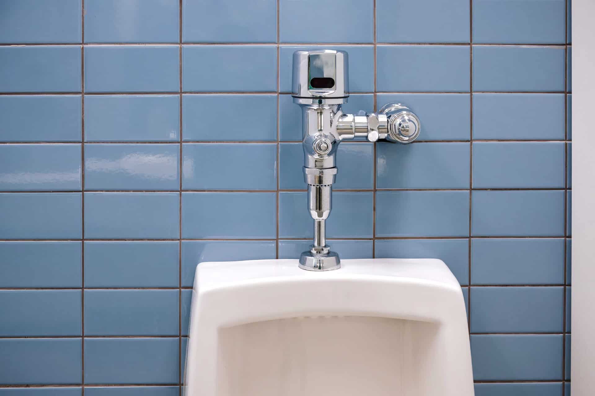Close up of an auto flushing ceramic urinal